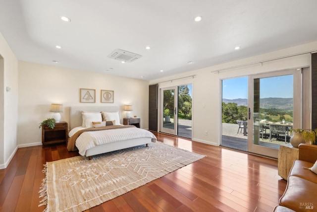 bedroom featuring recessed lighting, baseboards, access to exterior, and hardwood / wood-style floors