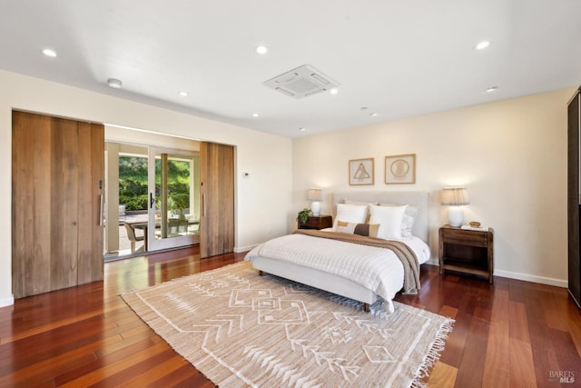 bedroom featuring baseboards, recessed lighting, and wood finished floors