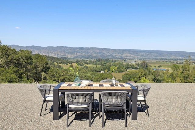 view of patio / terrace featuring a mountain view and outdoor dining space
