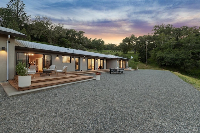 rear view of property featuring a wooden deck