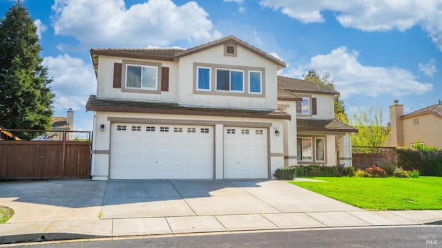 traditional-style house featuring stucco siding, fence, a front yard, a garage, and a tiled roof