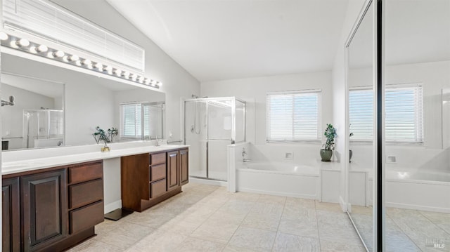 full bathroom with a bath, a sink, a shower stall, and double vanity