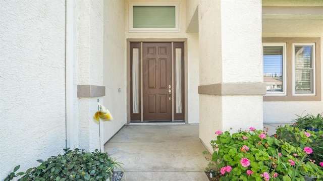 doorway to property with stucco siding