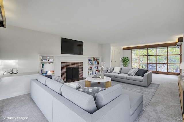 carpeted living room featuring a fireplace and baseboards