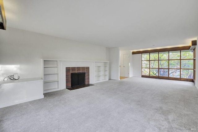 unfurnished living room with a brick fireplace, built in features, and carpet