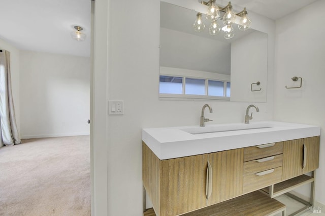 bathroom featuring double vanity, baseboards, and a sink