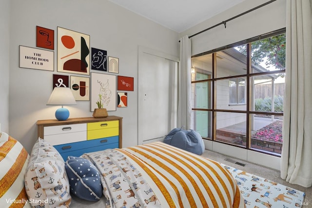bedroom featuring a closet, visible vents, and carpet floors