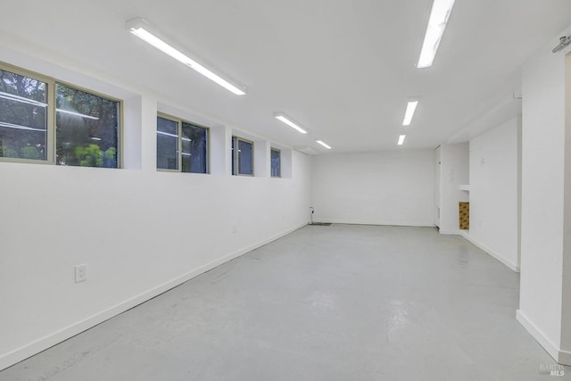 interior space featuring concrete flooring and baseboards