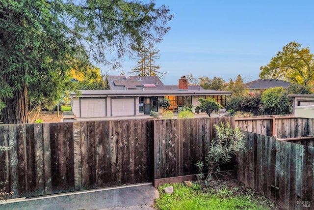 view of yard with a fenced front yard and an attached garage