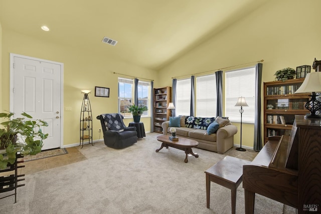 living room with tile patterned floors, visible vents, carpet flooring, baseboards, and vaulted ceiling