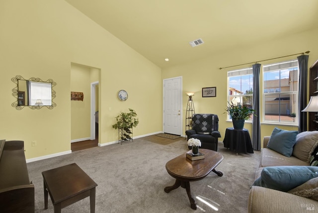 living room featuring visible vents, carpet floors, high vaulted ceiling, and baseboards