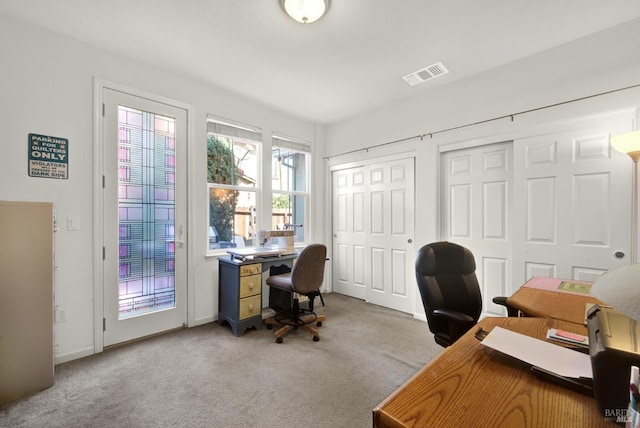 home office with carpet, visible vents, and baseboards