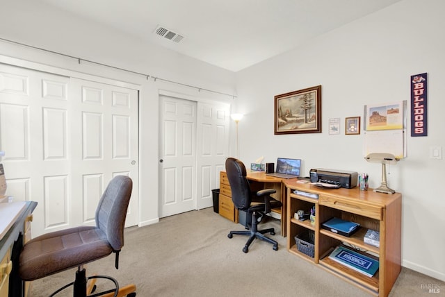 home office with light carpet, visible vents, and baseboards