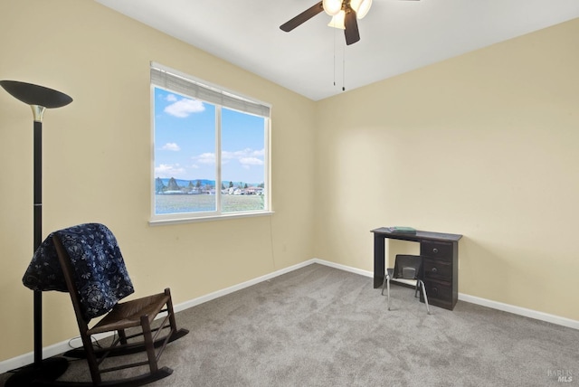 living area with baseboards, a ceiling fan, and carpet floors
