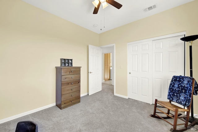 living area with visible vents, carpet floors, baseboards, and ceiling fan
