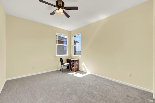 unfurnished room featuring baseboards, carpet floors, and a ceiling fan