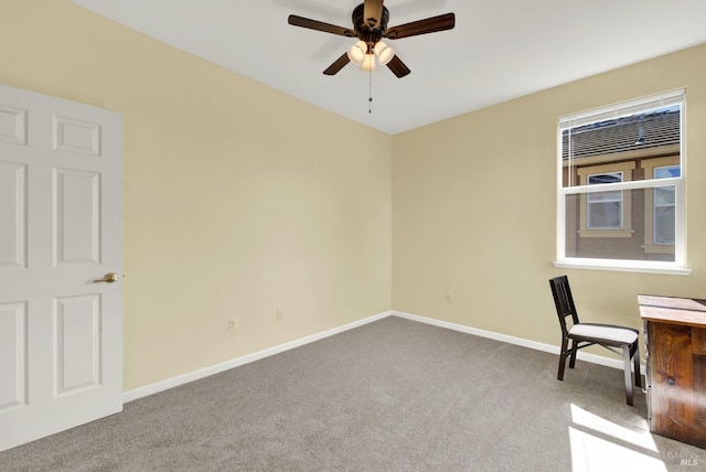 unfurnished office featuring a ceiling fan, baseboards, and carpet floors