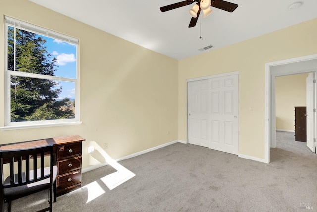 unfurnished bedroom with visible vents, baseboards, ceiling fan, carpet flooring, and a closet