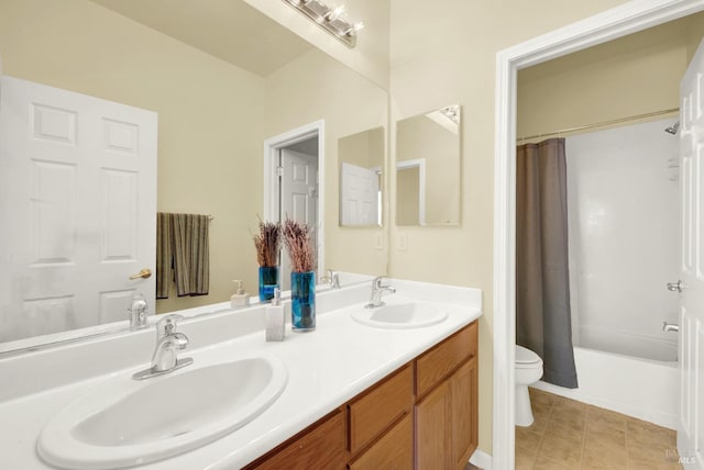 bathroom featuring double vanity, shower / bathtub combination with curtain, toilet, and a sink