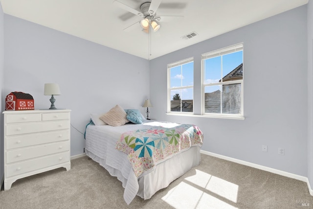 bedroom featuring visible vents, carpet floors, baseboards, and a ceiling fan