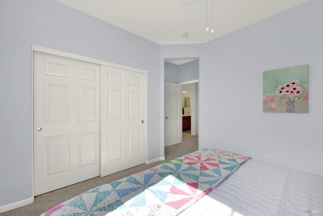 bedroom with a closet, baseboards, and carpet