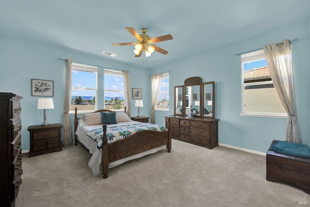 bedroom with multiple windows, carpet flooring, baseboards, and visible vents
