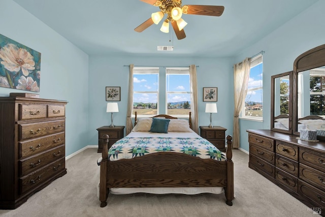 bedroom featuring light carpet, visible vents, ceiling fan, and baseboards