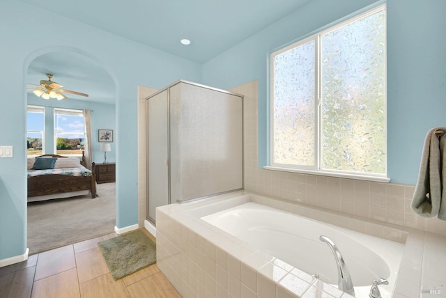 ensuite bathroom with a bath, a stall shower, ensuite bath, and a ceiling fan