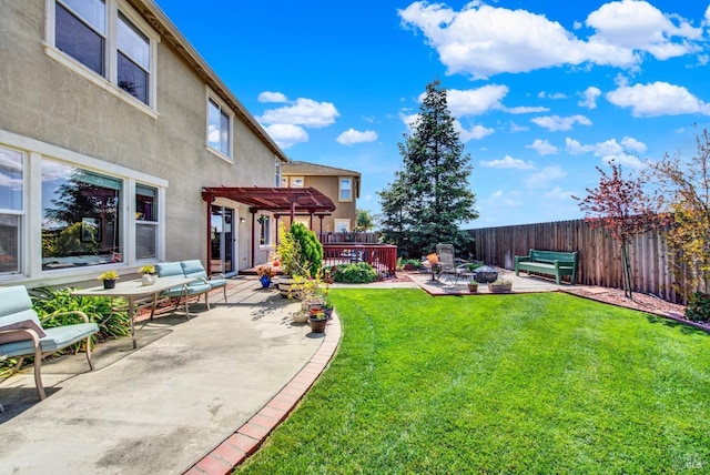 view of yard with a patio, fence, a pergola, and a wooden deck