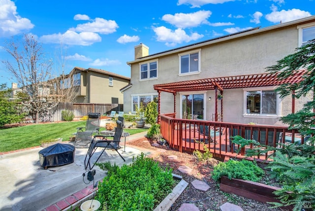back of house featuring fence, an outdoor fire pit, stucco siding, a chimney, and a pergola