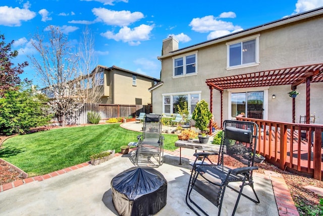view of patio with a pergola and fence
