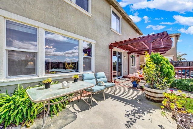 view of patio with a pergola and fence