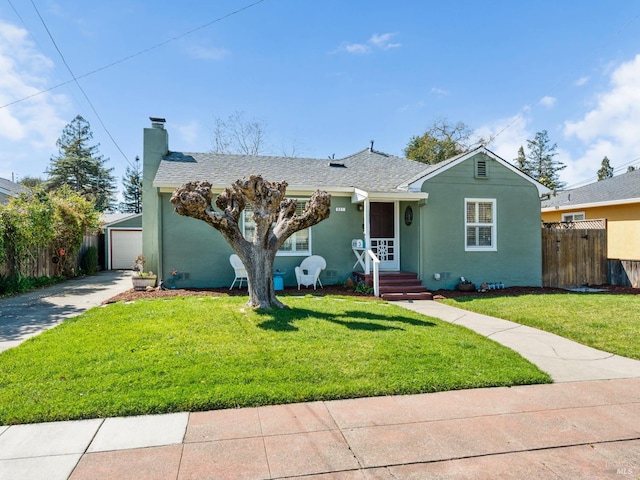 ranch-style home with a front lawn, fence, a detached garage, and a chimney