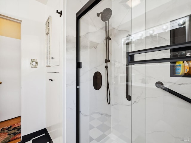 full bath featuring a marble finish shower