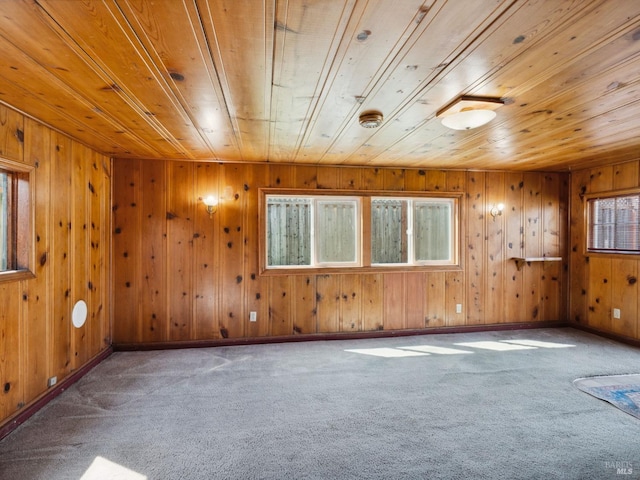 empty room with wooden ceiling, baseboards, and carpet floors