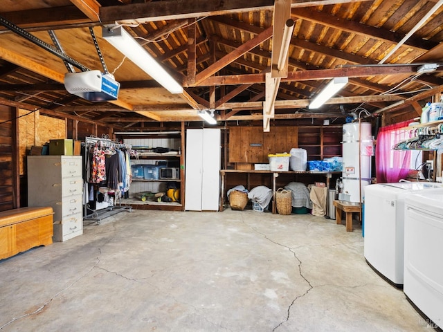 garage featuring strapped water heater, a garage door opener, and washing machine and clothes dryer
