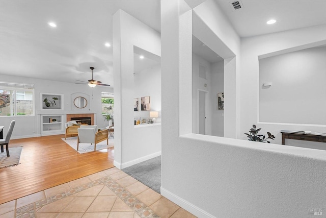 hall with light tile patterned floors, recessed lighting, baseboards, and visible vents