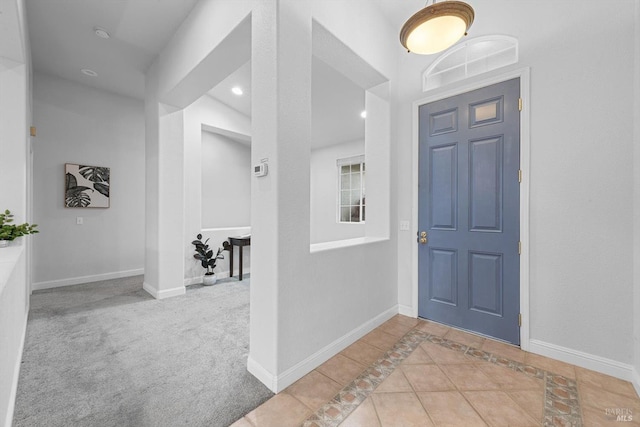 entryway featuring baseboards, carpet, tile patterned flooring, and recessed lighting