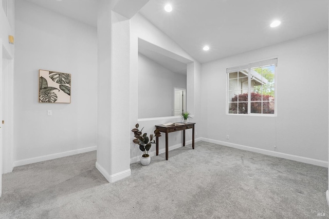 spare room with baseboards, carpet, lofted ceiling, and recessed lighting
