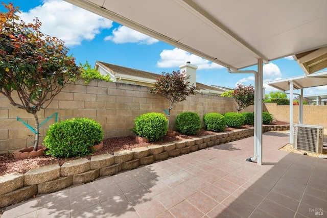 view of patio with central AC unit and a fenced backyard