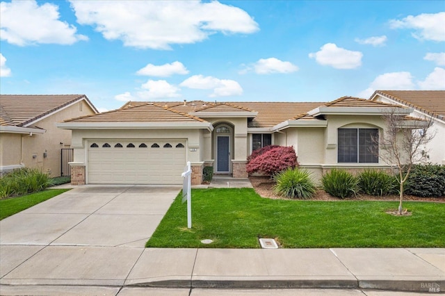 view of front facade featuring a front lawn, driveway, stucco siding, and a tiled roof