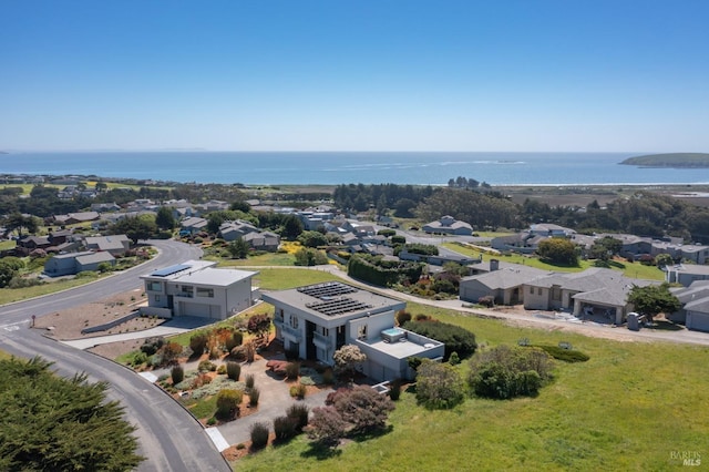 drone / aerial view with a residential view and a water view