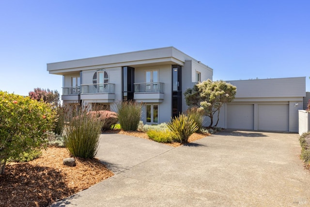 view of front of property with a balcony and driveway