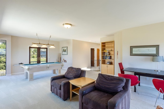 living room featuring light colored carpet, pool table, and baseboards