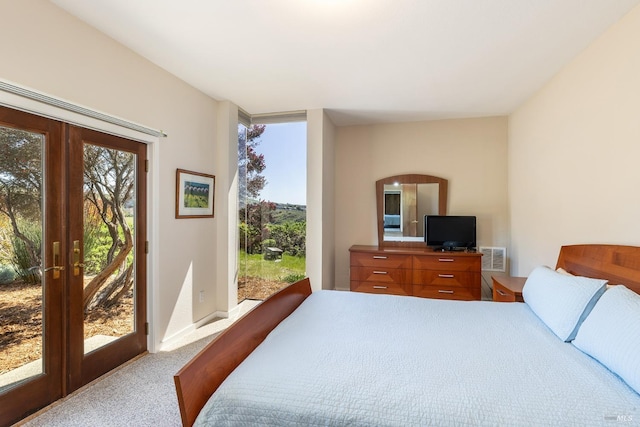carpeted bedroom with french doors, visible vents, and access to exterior