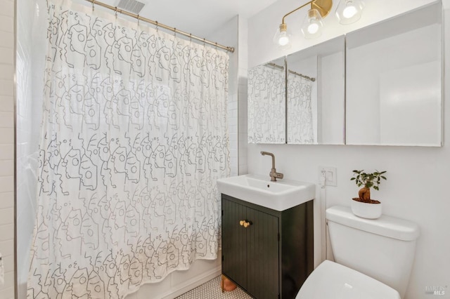 full bath with visible vents, toilet, vanity, and shower / tub combo