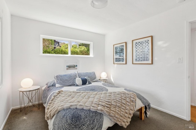 bedroom with baseboards and carpet flooring