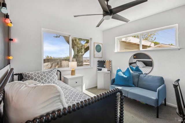 carpeted bedroom featuring baseboards and a ceiling fan