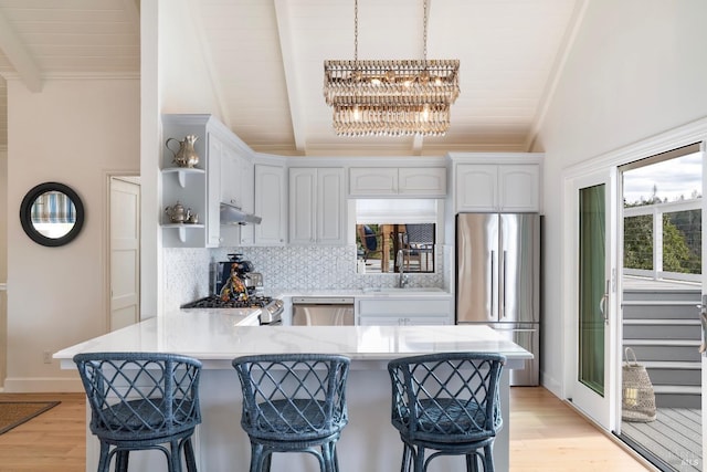 603 Sunnyside Rd, Saint Helena, CA 94574 - kitchen featuring a kitchen bar, an inviting chandelier, lofted ceiling with beams, stainless steel appliances, and a peninsula
