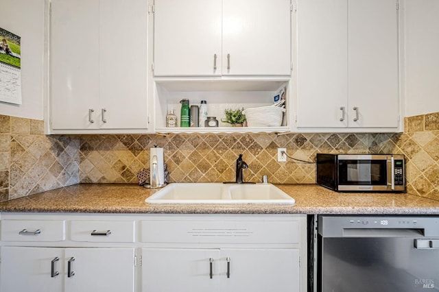 kitchen with a sink, white cabinetry, and appliances with stainless steel finishes
